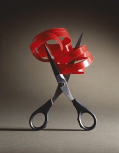 scissors cutting red tape